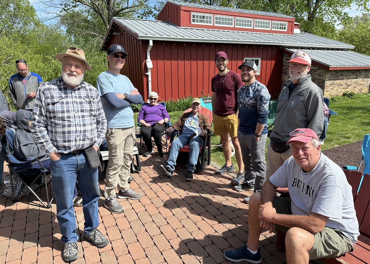 Spring picnic 2024 members seated outside shelter